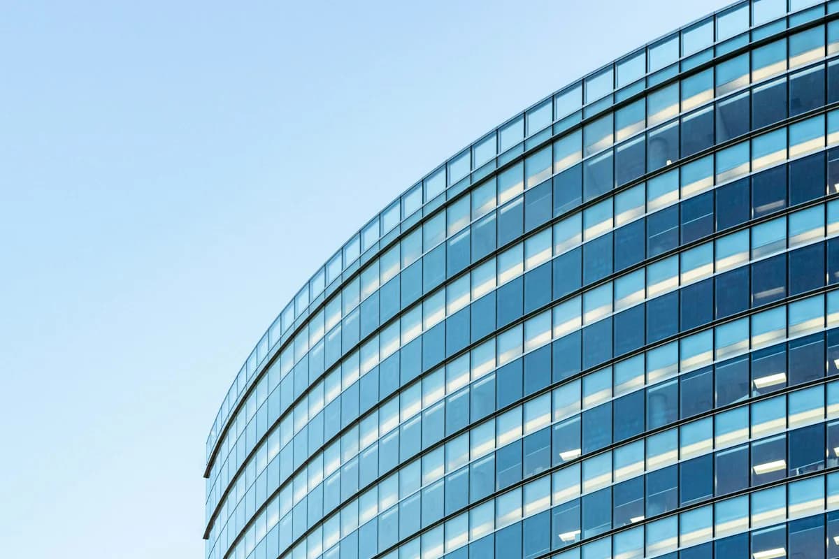 The curved glass facade of a commercial office building