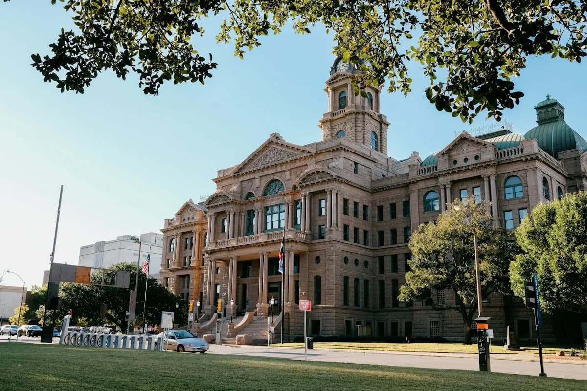 A historic county courthouse behind trees